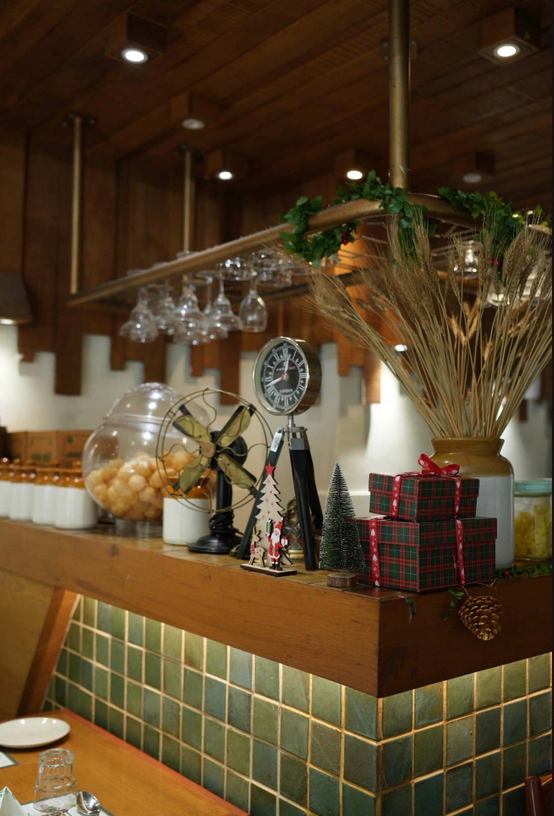 Wooden counter and green tiles inside Rasila’s Kitchen